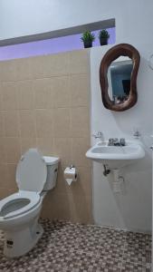 a bathroom with a toilet and a sink at Refugio del Mar in Puerto Escondido +13 photos
