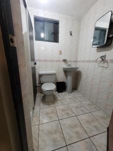 a bathroom with a toilet and a sink at Habitaciones Comfort Centricas Durango in Durango