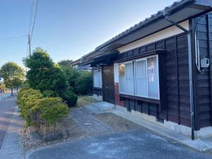 a house with a window on the side of it at 釣り宿yasakabase guesthouse in Sado