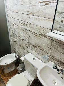 a bathroom with a white toilet and a sink at El Resguardo in San Luis