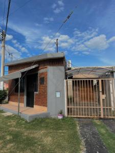 a brick house with a gate in front of it at El Resguardo in San Luis