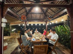 a group of people sitting around a table in a restaurant at Melalueca tay ninh in Tây Ninh