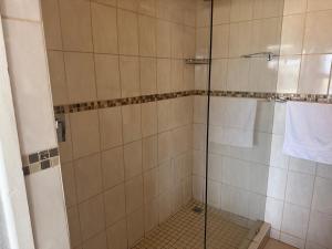 a shower with a glass door in a bathroom at 37 Laguna La Crete in Margate