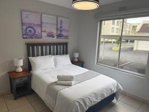 a bedroom with a bed and a large window at 37 Laguna La Crete in Margate