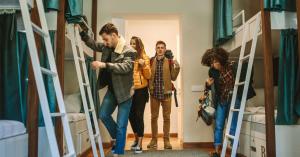 a group of people standing in a room with bunk beds at Bposhtels San Francisco in San Francisco