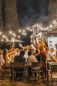 a group of people sitting at tables at a restaurant at La Vecchia cantina Guzzardi in Lari +61 photos
