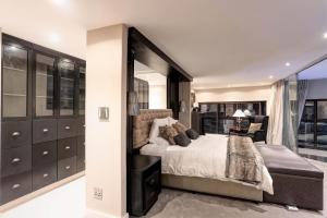 a bedroom with a large bed and a chair at Ocean View Penthouse in Strand