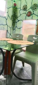 a wooden table with a chair and a stone wall at Viktor 's rooms for rent in Maria