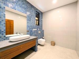 a bathroom with a sink and a toilet at Pinthaliya Resort in Sigiriya