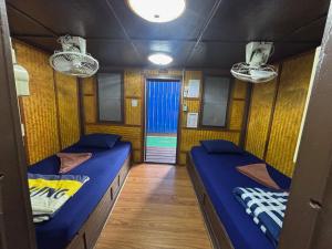 two beds in a room with a hallway at New Hut Bungalow in Lamai