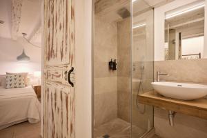 a bathroom with a glass shower and a sink at Can Savella - Turismo de Interior in Palma de Mallorca +108 photos