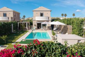 an aerial view of a villa with a swimming pool at Klio by Vintage Travel in Agios Georgios
