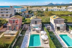 an aerial view of a house with a swimming pool at Erato by Vintage Travel in Tsoukalades