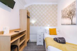 a small bedroom with two beds and a desk at Blackpool Lodge in Blackpool