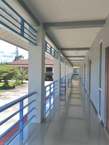 an empty hallway of a school building with blue railing at โรงแรมสิริพรชัย 2 in Takua Pa +1 photo