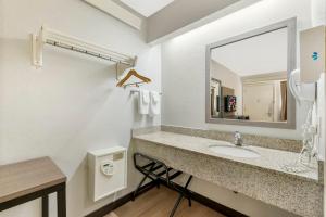 a bathroom with a sink and a mirror at Red Roof Inn Buffalo - Niagara Airport in Williamsville +32 photos