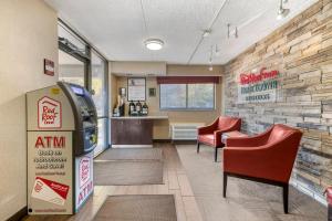 a restaurant with an atm machine in a waiting room at Red Roof Inn Buffalo - Niagara Airport in Williamsville