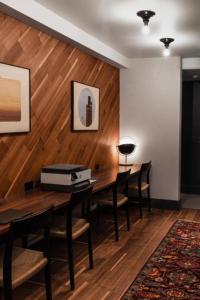 a dining room with a table and chairs and wooden walls at Bposhtels San Francisco in San Francisco