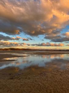 a reflection of the sky in a body of water at Sailors Snug in Kelso