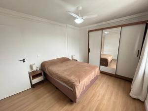 a bedroom with a bed and a large mirror at Ed Las Vegas by Select Stays in Chapecó