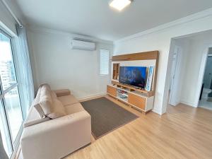 a living room with a couch and a tv at Ed Las Vegas by Select Stays in Chapecó
