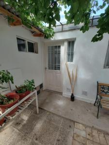 a white door of a house with potted plants at brisa azul in General Roca