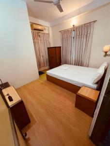 a small bedroom with a bed and a television at Bhuddha Bhoomi Lodge in Rummindei