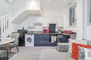 a kitchen and living room with a washer and dryer at Pleasant and snuggly modern 2-floored town centre apartment in Hull