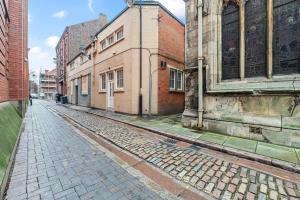 an empty street in an old city with buildings at Pleasant and snuggly modern 2-floored town centre apartment in Hull