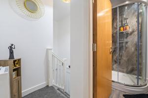 a glass shower in a room with a staircase at Pleasant and snuggly modern 2-floored town centre apartment in Hull +27 photos