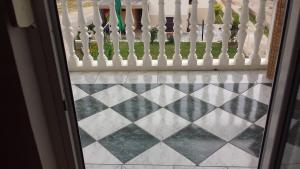 a view from the door of a white picket fence at Apartmani kod Rade in Pakoštane