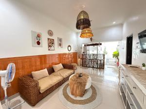 a living room with a couch and a table at Homestay Aesthetic Jogja in Gondowulung