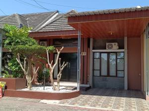 a house with a glass door in front of it at Homestay Aesthetic Jogja in Gondowulung