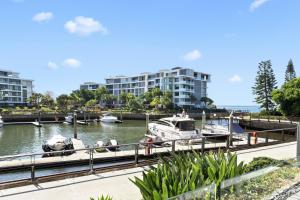 a couple of boats docked at a marina at Allisee Apartments in Gold Coast