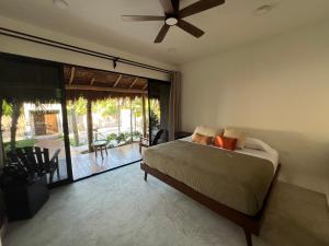 a bedroom with a bed and a ceiling fan at Nomads Kite House in El Cuyo