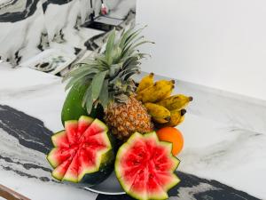a plate with a pineapple and other fruits on a table at Blue Cinnamon Cove in Kosgoda