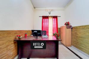 an office with a desk with a sign on it at Super Hotel O Kollamkudimughal Kakkanad Formerly Diamond Inn in Kakkanad