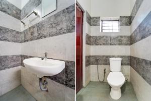 a bathroom with a sink and a toilet at Super Hotel O Kollamkudimughal Kakkanad Formerly Diamond Inn in Kakkanad