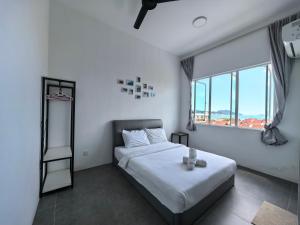 a bedroom with a bed and a large window at Langkawi Simfoni Premium Comfy 09 in Kuah +56 photos