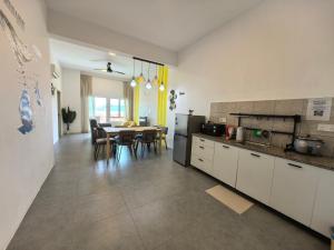a kitchen and dining room with a table and chairs at Langkawi Simfoni Premium Comfy 09 in Kuah