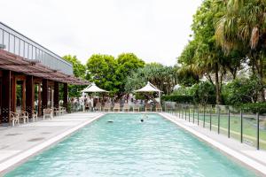 a swimming pool with two people in the water at Allisee Apartments in Gold Coast +12 photos