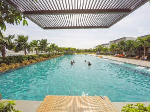 a pool at a resort with people in the water at Luxury Condominium at Loft Imago in Kota Kinabalu
