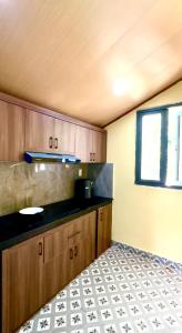 a kitchen with wooden cabinets and a tile floor at The mountain Seaview in Vung Tau