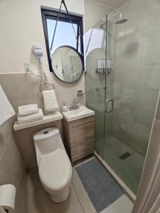 a bathroom with a shower and a toilet and a sink at Comfy Habitación en Puebla! in San Baltasar +12 photos