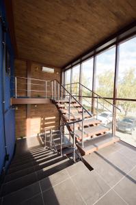 a metal staircase in a building with windows at Бизнес-отель Loft in Chelyabinsk