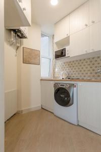 a kitchen with a washing machine in a room at Mais Guest House in Tbilisi City