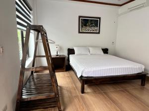 a bedroom with a bed and a ladder in it at Tam Coc Mountain Light Homestay in Ninh Binh