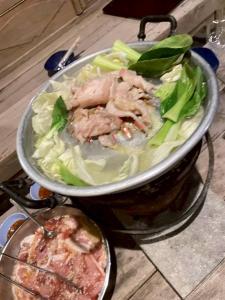 a pan of meat and vegetables on a stove at บ้านสุจิปุรี BaanSujipuri in Pak Chong +26 photos