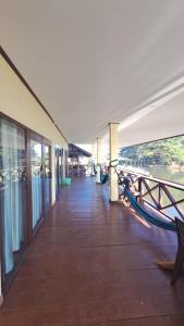 a dock with a boat on the side of a building at Riverside Bungalow Don Det in Don Det +24 photos