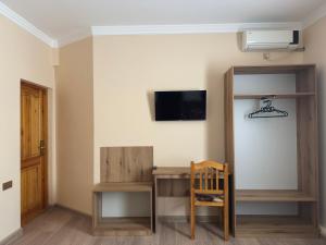 a room with a desk and a chair and a tv at KALA Khiva in Khiva